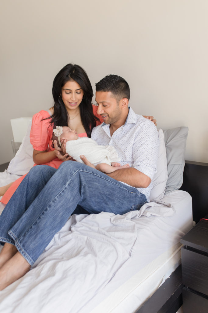 Mom and dad holding newborn during lifestyle session