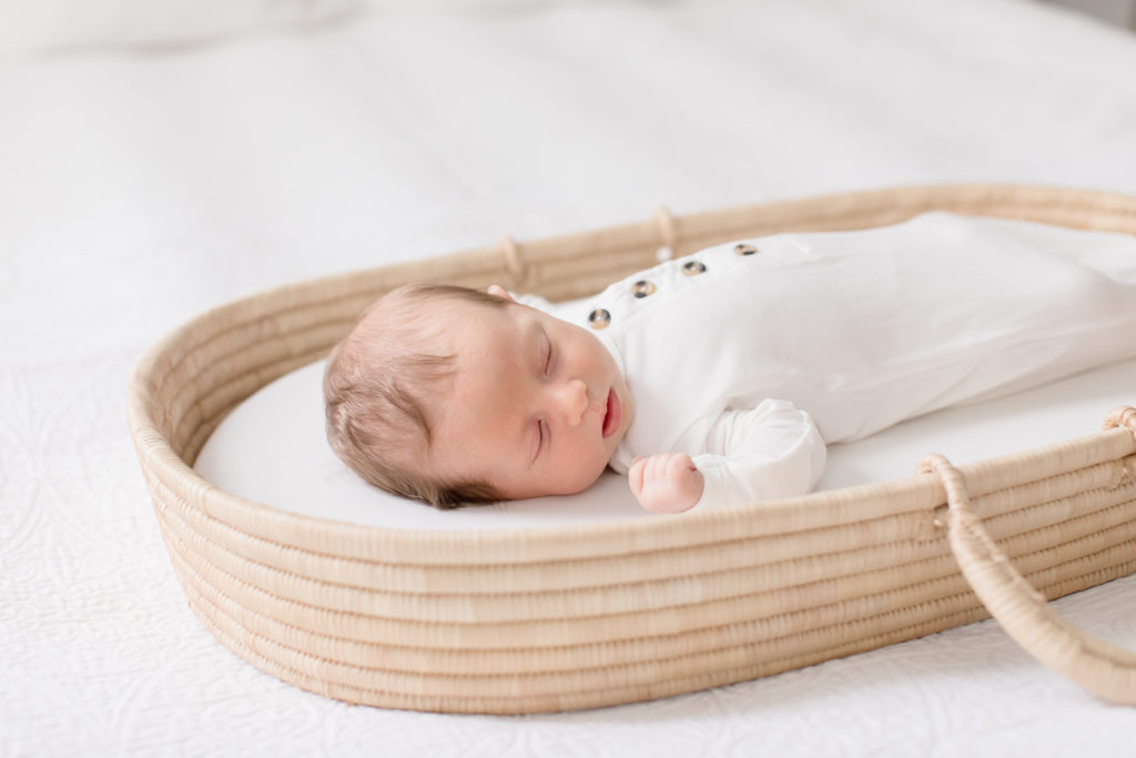 Sweet newborn sleeping during photography session